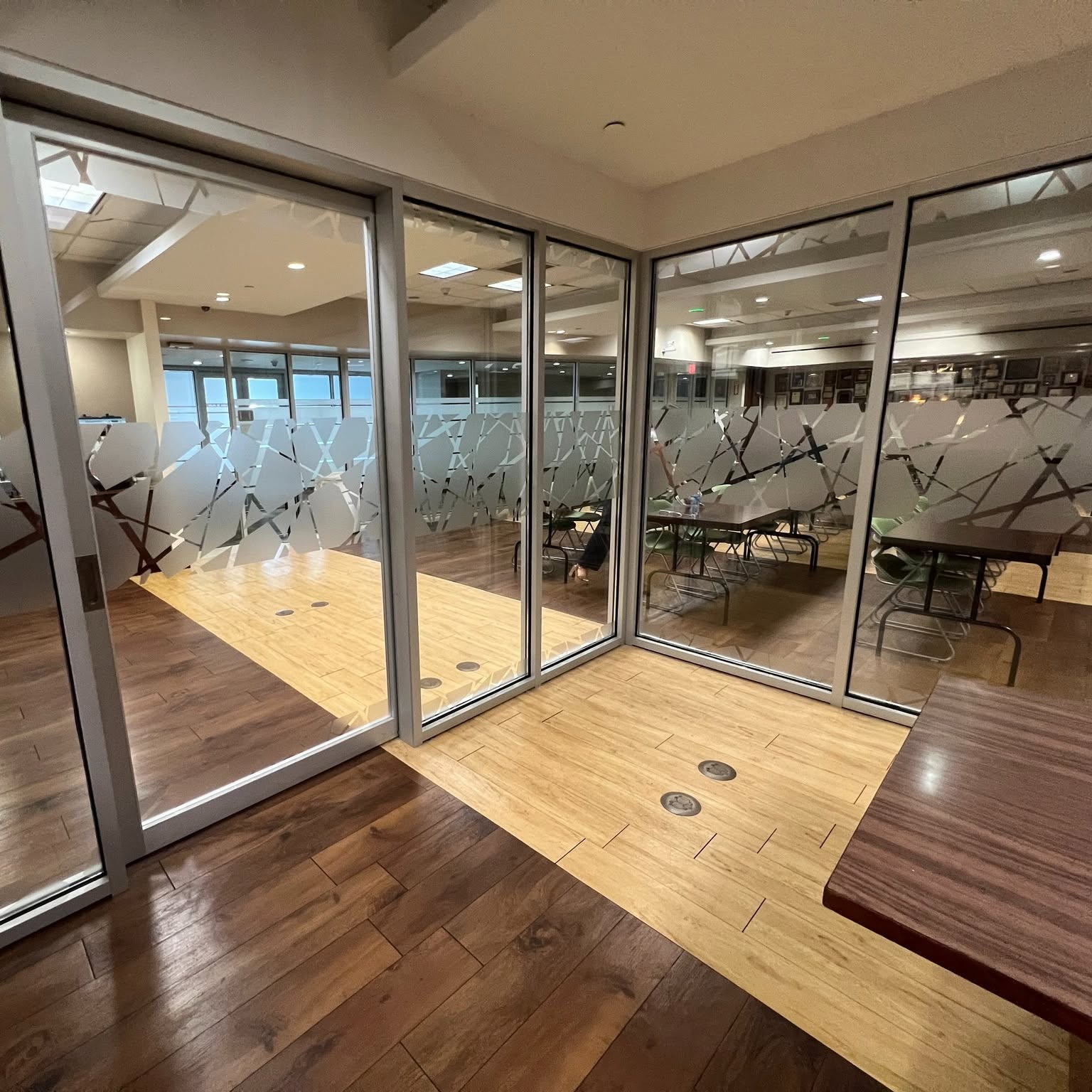 Custom decorative privacy film installed on glass office partitions