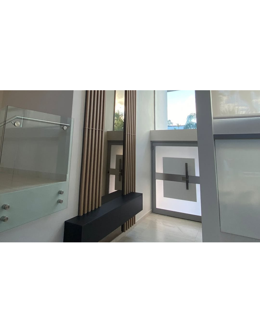 Modern architectural wrap installation with vertical wood slats, frosted glass and a contemporary entry door