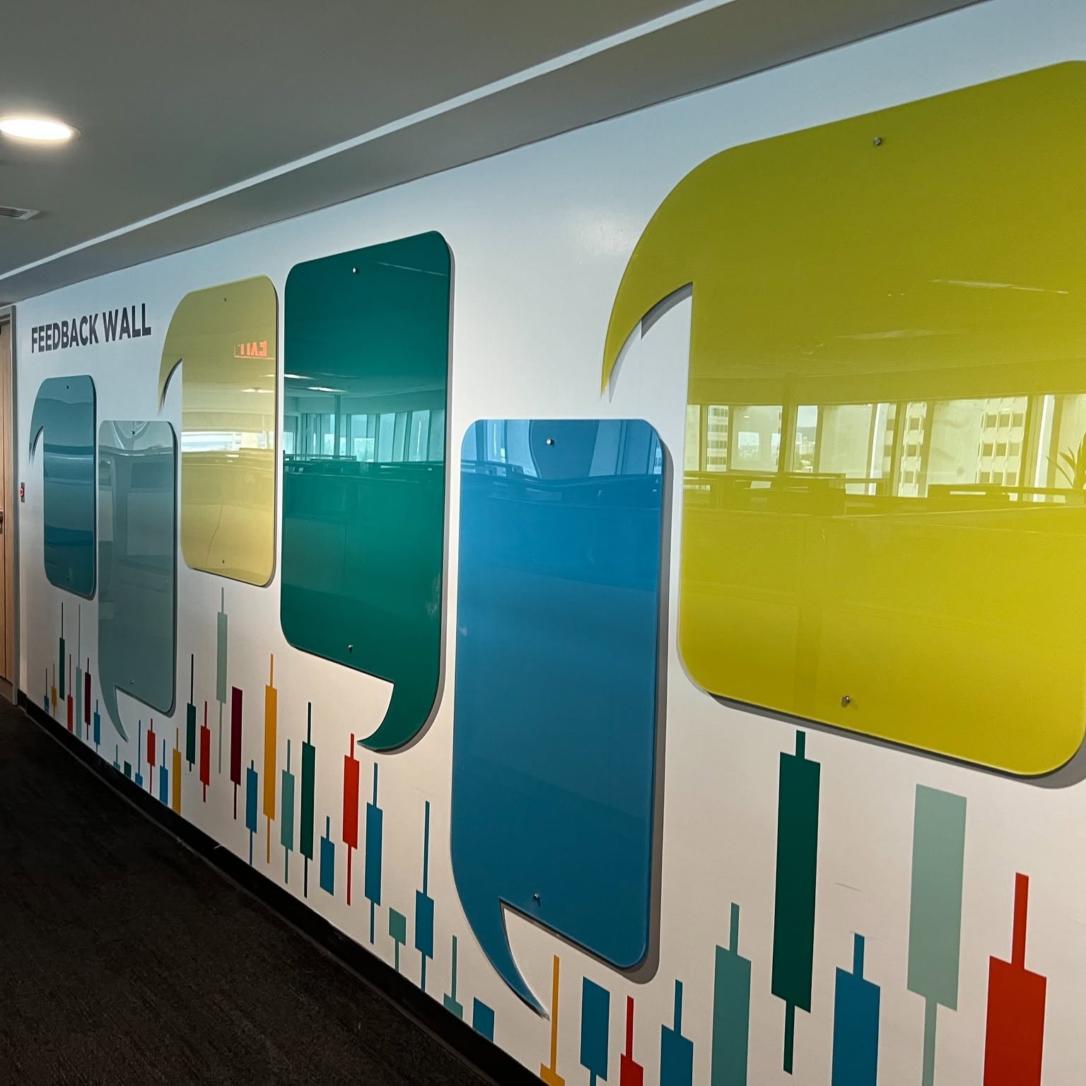 Custom feedback wall graphics with colorful speech bubble mirrors and chart accents